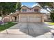 Two-story house with three car garage and manicured lawn at 3639 E San Pedro Ave, Gilbert, AZ 85234