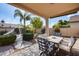 Covered patio with table and chairs, overlooking a grassy backyard at 3639 E San Pedro Ave, Gilbert, AZ 85234