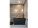 Modern powder room with floating vanity and exposed brick wall at 38484 N 94Th St, Scottsdale, AZ 85262