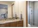 Bathroom with granite vanity, modern fixtures, and a walk-in shower at 38484 N 94Th St, Scottsdale, AZ 85262