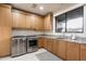 Laundry room with modern cabinetry, stainless steel appliances, and granite counters at 38484 N 94Th St, Scottsdale, AZ 85262