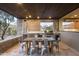 Outdoor kitchen and dining area with built-in grill and seating at 38484 N 94Th St, Scottsdale, AZ 85262