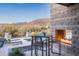 Outdoor patio with fire pit, seating, and mountain views at 38484 N 94Th St, Scottsdale, AZ 85262