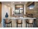 Home bar with granite countertop and wine storage at 38484 N 94Th St, Scottsdale, AZ 85262