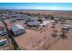 Aerial view showcasing a house, detached garage, and expansive land at 3936 E Ascot Dr, San Tan Valley, AZ 85140