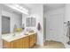 Bathroom features double vanity, shower, and light wood cabinets at 3936 E Ascot Dr, San Tan Valley, AZ 85140