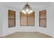 Bright dining room with a chandelier and three windows at 3936 E Ascot Dr, San Tan Valley, AZ 85140