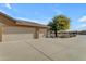 View of a large three car garage with long driveway at 3936 E Ascot Dr, San Tan Valley, AZ 85140