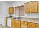 Kitchen features double sink, light wood cabinets, and tile flooring at 3936 E Ascot Dr, San Tan Valley, AZ 85140