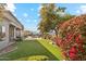 A lush backyard with a manicured lawn, flowers, and a mountain view at 402 E Windmere Dr, Phoenix, AZ 85048