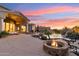 Inviting backyard featuring a cozy fire pit and a luxurious pool area at 402 E Windmere Dr, Phoenix, AZ 85048