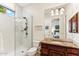 Bathroom featuring wood vanity, granite countertops, glass shower, and a toilet at 402 E Windmere Dr, Phoenix, AZ 85048