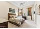 Inviting bedroom with tray ceilings, ceiling fan, and beautiful natural light from two windows at 402 E Windmere Dr, Phoenix, AZ 85048