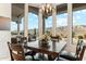 Bright dining room with mountain views and modern chandelier lighting above the wood table at 402 E Windmere Dr, Phoenix, AZ 85048