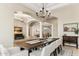 Formal dining area with hardwood floors, a long table, and seating for eight, perfect for entertaining at 402 E Windmere Dr, Phoenix, AZ 85048