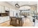 Bright kitchen featuring a central island, custom cabinetry, and a large window with views at 402 E Windmere Dr, Phoenix, AZ 85048