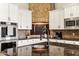 Close up of the gourmet kitchen boasting custom cabinets and stainless steel appliances at 402 E Windmere Dr, Phoenix, AZ 85048