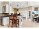 Kitchen with island seating, stainless steel appliances, and adjacent dining area with views at 402 E Windmere Dr, Phoenix, AZ 85048