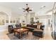 Open concept living room offers comfortable seating, ceiling fan, neutral color palette, and bar area at 402 E Windmere Dr, Phoenix, AZ 85048