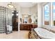 Luxurious main bathroom features tiled platform tub, walk-in shower with glass blocks and granite at 402 E Windmere Dr, Phoenix, AZ 85048