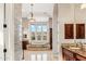 Luxurious main bathroom featuring tiled platform tub with mountain views from the window at 402 E Windmere Dr, Phoenix, AZ 85048