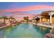 Gorgeous swimming pool with rock waterfall feature and lush landscaping at 402 E Windmere Dr, Phoenix, AZ 85048