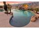 Captivating pool area showcasing the serene mountain backdrop and lush tropical landscaping at 402 E Windmere Dr, Phoenix, AZ 85048