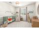 Bedroom featuring a crib, armchair, and neutral color scheme at 4176 E Glacier Pl, Chandler, AZ 85249