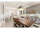 Elegant dining room features a rustic wood table and stylish light fixture at 4176 E Glacier Pl, Chandler, AZ 85249