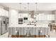 Modern white kitchen with granite island, stainless steel appliances, and white cabinetry at 4176 E Glacier Pl, Chandler, AZ 85249