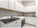 Bright laundry room with white cabinets and Maytag appliances at 4176 E Glacier Pl, Chandler, AZ 85249