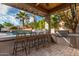 Outdoor kitchen and pool area with seating and a TV at 4176 E Glacier Pl, Chandler, AZ 85249