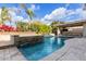 Expansive pool and patio with built-in bar and fire pit; ultimate luxury at 4176 E Glacier Pl, Chandler, AZ 85249