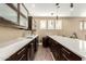 Modern wet bar with dark wood cabinetry and quartz countertop at 4176 E Glacier Pl, Chandler, AZ 85249