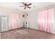 Bedroom with pink curtains and ceiling fan at 4322 E Whitehall Dr, San Tan Valley, AZ 85140