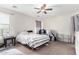 Bedroom with striped bedding, ceiling fan and crib at 4322 E Whitehall Dr, San Tan Valley, AZ 85140