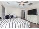 Bedroom with striped bedding, ceiling fan and dresser at 4322 E Whitehall Dr, San Tan Valley, AZ 85140