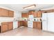 Bright kitchen with oak cabinets, white appliances, and tile flooring at 4322 E Whitehall Dr, San Tan Valley, AZ 85140