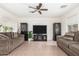 Living room with two sofas, a large TV, and tile floors at 4322 E Whitehall Dr, San Tan Valley, AZ 85140