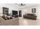 Living room with two sofas, a large TV, and tile floors at 4322 E Whitehall Dr, San Tan Valley, AZ 85140