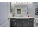 Bathroom with dark vanity, marble countertop, and shower/tub combo at 4329 E Swilling Rd, Phoenix, AZ 85050