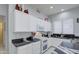 Modern kitchen with white cabinets and granite counters at 4329 E Swilling Rd, Phoenix, AZ 85050