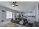 Open living area with gray sofas, a fireplace, and large windows at 4329 E Swilling Rd, Phoenix, AZ 85050