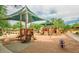 Community playground with shaded areas and play equipment for children at 4329 E Swilling Rd, Phoenix, AZ 85050