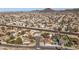 Expansive aerial view of a residential neighborhood featuring homes, streets, and mountain views in the distance at 4542 W Villa Theresa Dr, Glendale, AZ 85308