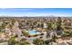 Panoramic aerial shot showcases a community pool, tree-lined streets, and well-maintained homes in a scenic setting at 4542 W Villa Theresa Dr, Glendale, AZ 85308