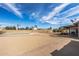 Expansive backyard with a pool, patio area, and potential for landscaping under a bright sky at 4542 W Villa Theresa Dr, Glendale, AZ 85308