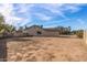 Side view of the home's exterior showing the spacious backyard and a brick perimeter wall at 4542 W Villa Theresa Dr, Glendale, AZ 85308