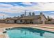 View of backyard with a pool, covered patio, and well-maintained lawn at 4542 W Villa Theresa Dr, Glendale, AZ 85308