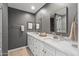 Stylish bathroom featuring dual sinks, gray walls, and a modern walk-in shower at 4542 W Villa Theresa Dr, Glendale, AZ 85308